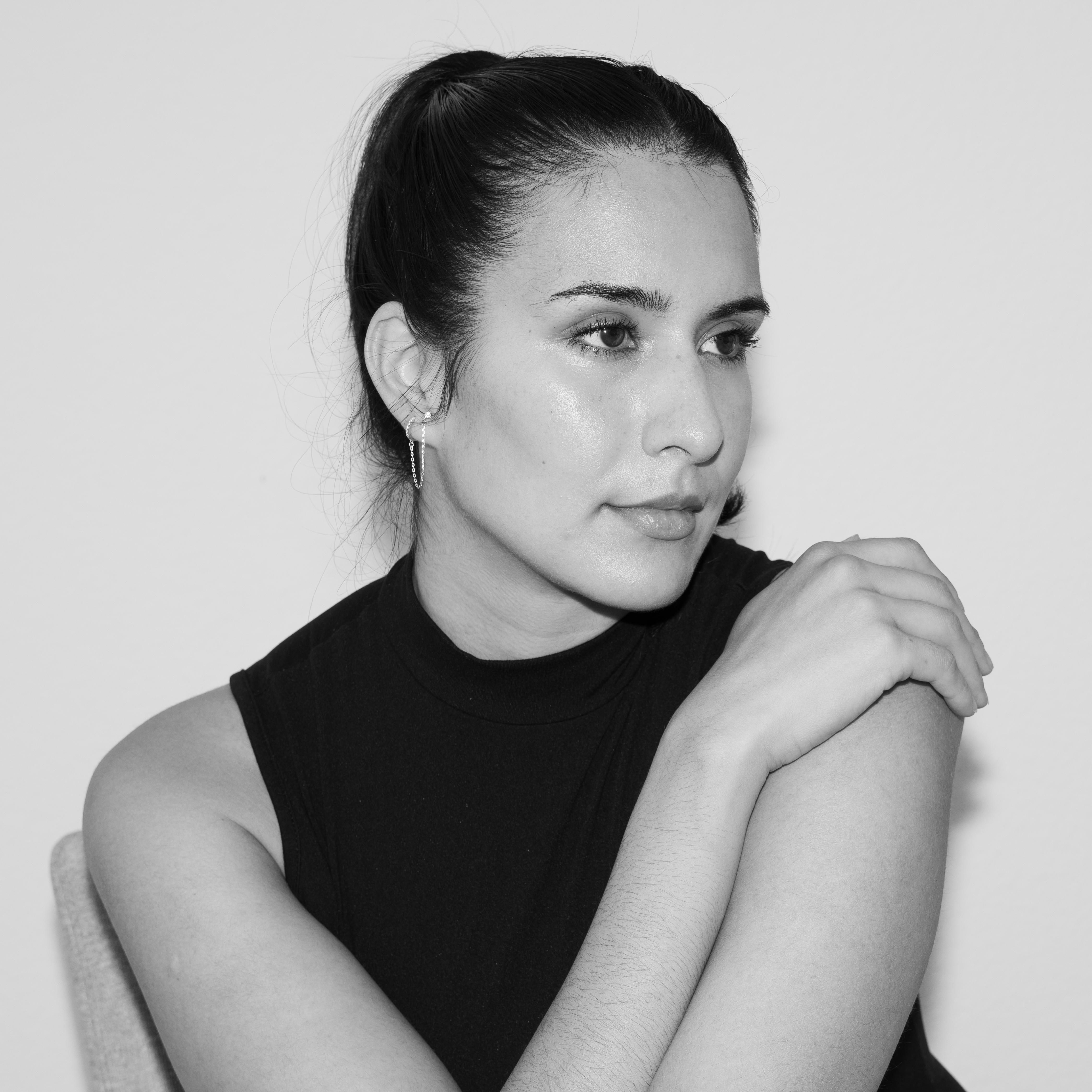 Black and white studio headshot, subject looking off camera